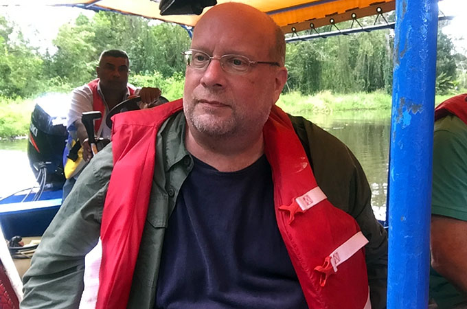 Photo of Byron Adams on a boat, wearing a red life vest.